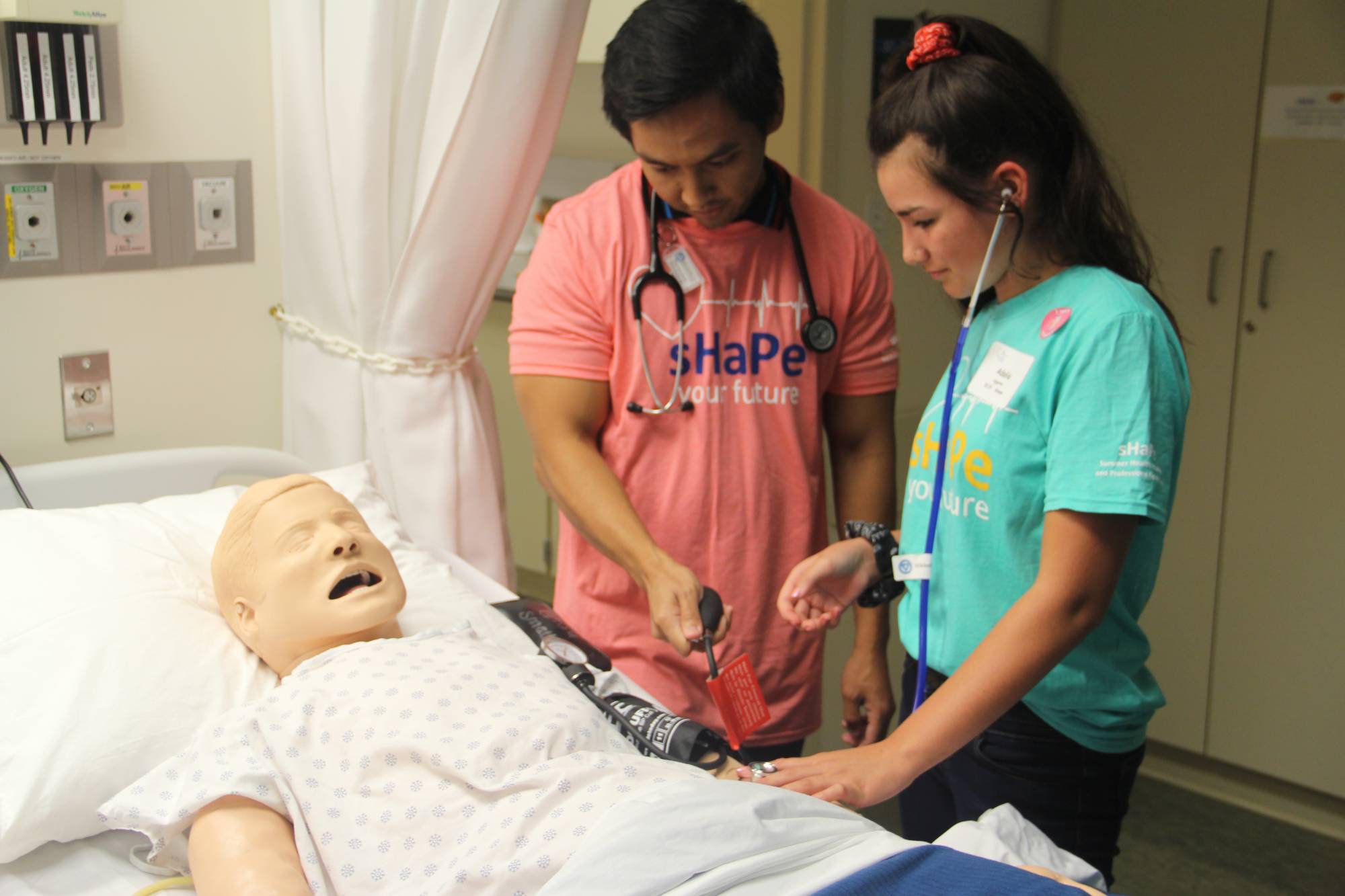 SHAPE Camp Students Working with CPR Dummy